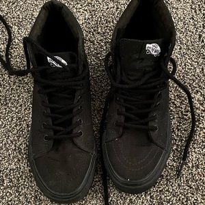All black high top Vans